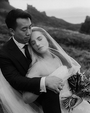 Groom and bride cudle at the Quiraing on their elopement day